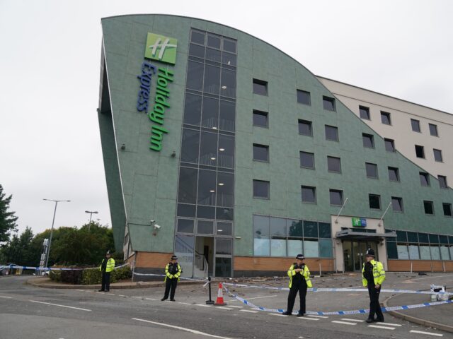 Police at the Holiday Inn Express in Tamworth, Staffordshire, after a mob attacked it on S