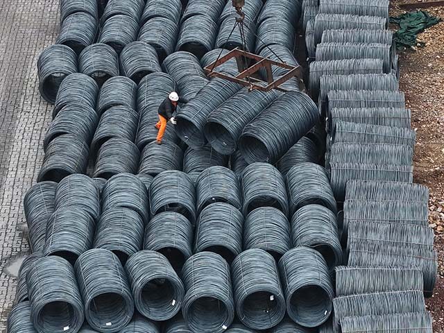 The steel is hoisted and stacked at a steel market in Hangzhou, Zhejiang province, China,