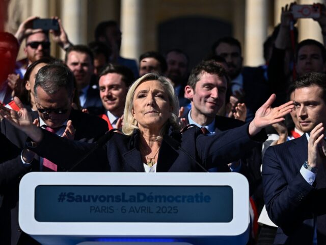 TOPSHOT - RN party's President Jordan Bardella (R) applauds as President of Rassemblement