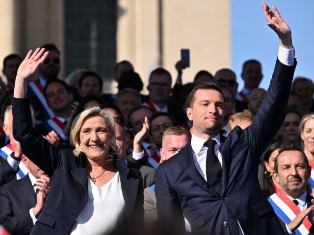 PARIS, FRANCE - APRIL 06: RN party's President Jordan Bardella (R) applauds as President o