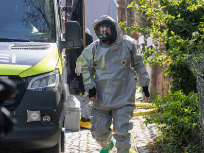 17 April 2025, Saxony, Zeithain: A firefighter in a protective suit prepares for his missi