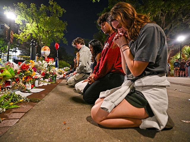 Students hold a vigil near the scene of a shooting near the Florida State University stude