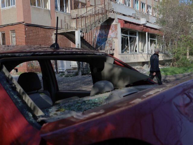 A man walks past a damaged building following a Russian drones strike in Odesa on April 22