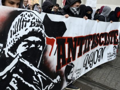 Protesters hold a banner reading "Antifacist" as they take part to a demonstration in Lyon