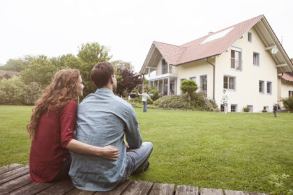 Couple in backyard of new home