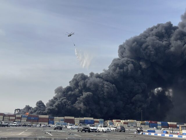 In this photo provided by Iranian Students' News Agency, ISNA, a helicopter drops wat