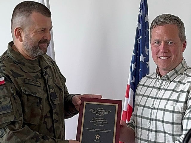 U.S. Army Secretary Dan Driscoll presents the Army Community Partnership Award to Polish B