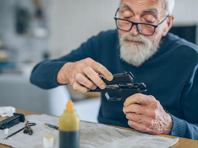 Man disassembling gun