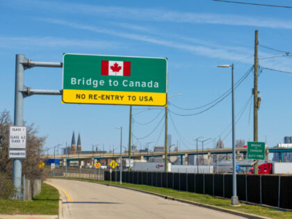 Signs notify drivers at the US-Canada Ambassador Bridge border crossing in Detroit, Michig
