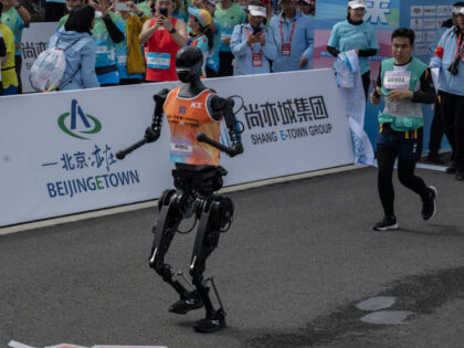 BEIJING, CHINA - APRIL 19: A Humanoid robot called Tiangong runs after the finish line in