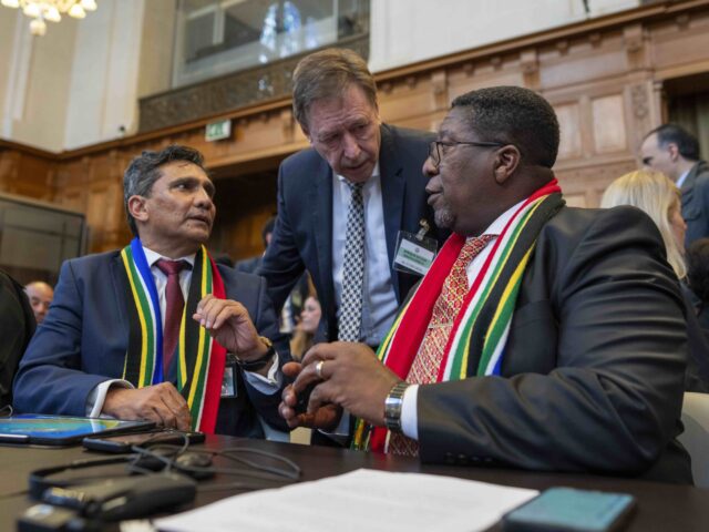 South Africa's agents Vusimuzi Madonsela, seated right, and Cornelius Scholtz, seated