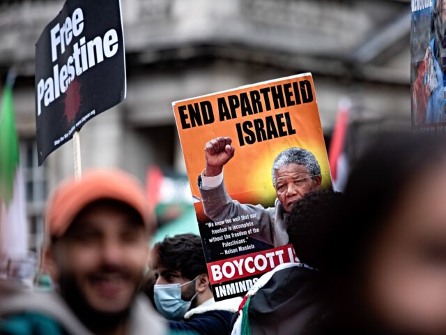 anti-israel LONDON, UNITED KINGDOM - 2021/05/15: A placard with a portrait of Nelson Mandela seen duri