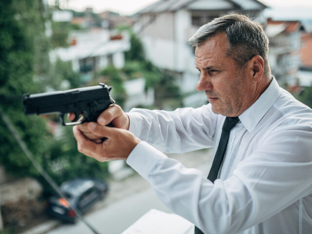 man with gun in daytime