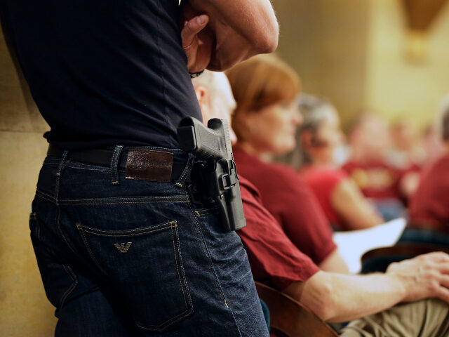 permit to carry A Glock handgun is holstered on the side of Kristopher Kranz of Bloomington, Minn., as he