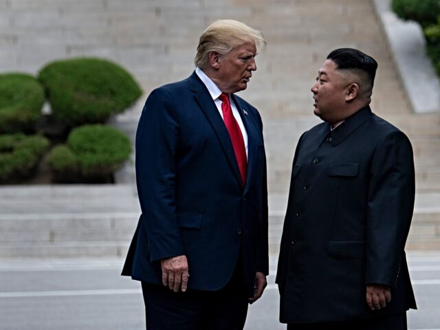 trump and Kim Jong-un TOPSHOT - US President Donald Trump and North Korea's leader Kim Jong-un stand on North Ko