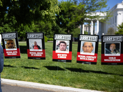 Stephen Miller, deputy White House chief of staff for policy, walks past images of people