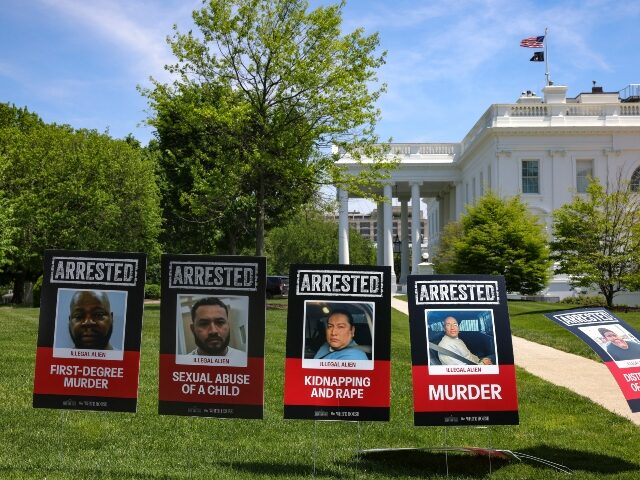 Posters depicting arrested illegal immigrants who had committed crimes are posted on the N