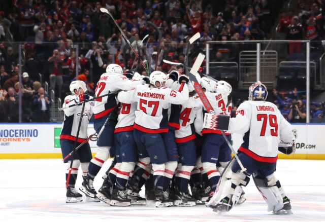 Alex Ovechkin is mobbed by team-mates after scoring his history-making 895th career goal,