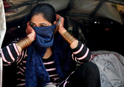 An Indian woman travels in a vehicle as she returns to her country from the Pakistan-India