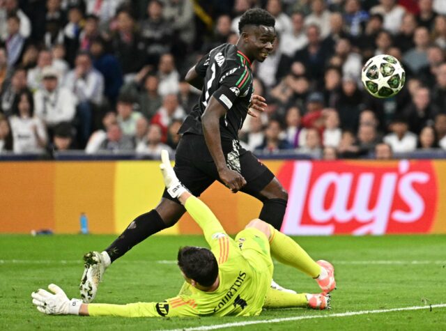 Arsenal's Bukayo Saka chipped home his side's opening goal over Thibaut Courtois