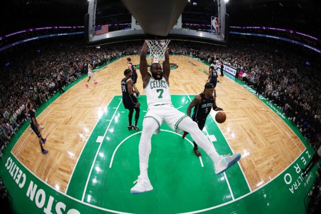 Boston's Jaylen Brown reacts after making a slam dunk in the Celtics' NBA playoff victory