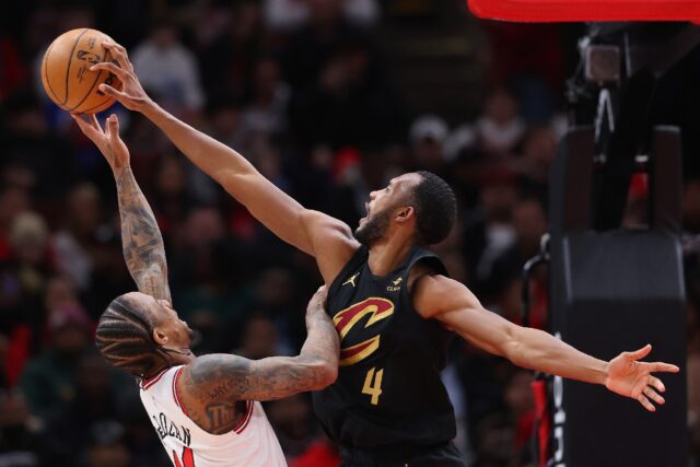 Evan Mobley of the Cleveland Cavaliers, at right blocking a shot by Chicago's DeMar DeRoza
