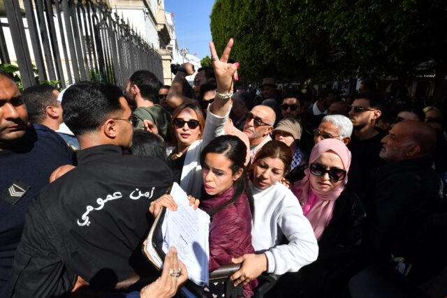 Journalist and rights activist Chaima Issa, seen flashing the victory sign outside the cou