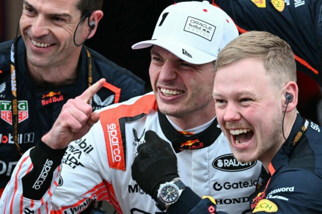 Max Verstappen (white cap) celebrates victory with his team members after the Japanese Gra