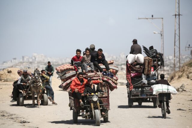Palestinians heading south along a coastal road from Gaza City, as Israel expands operatio