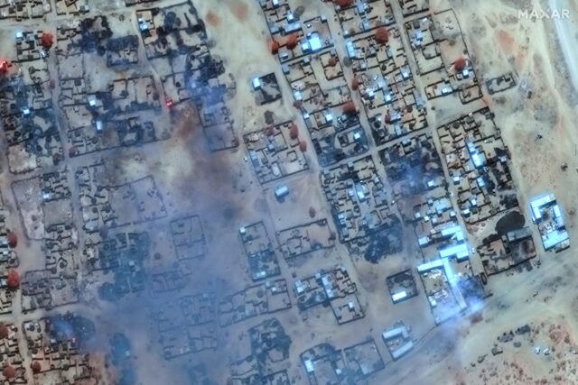 A satellite photo provided by Maxar Technologies shows smoke billowing and buildings burne
