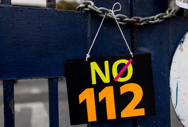 A sign is displayed outside the Criminal Court during a protest against article 112, Thail
