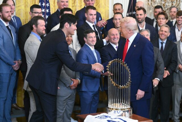 US President Donald Trump congratulates Shohei Ohtani as he receives the Los Angeles Dodge