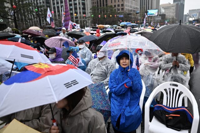 Yoon's supporters took to the streets in capital Seoul and braved the rain, chanting sloga
