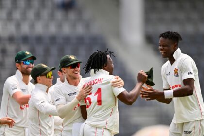 Zimbabwe's Blessing Muzarabani (R) celebrates with his teammates after taking the wicket o