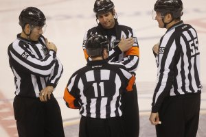 NHL linesman inadvertently checked into boards during Wild-Golden Knights opener