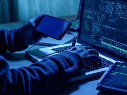 A spy downloads information to a tablet