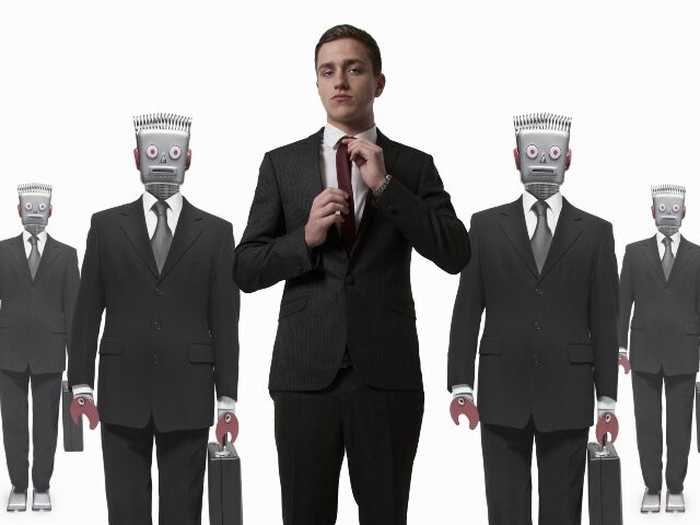 A worker in front of robot workers