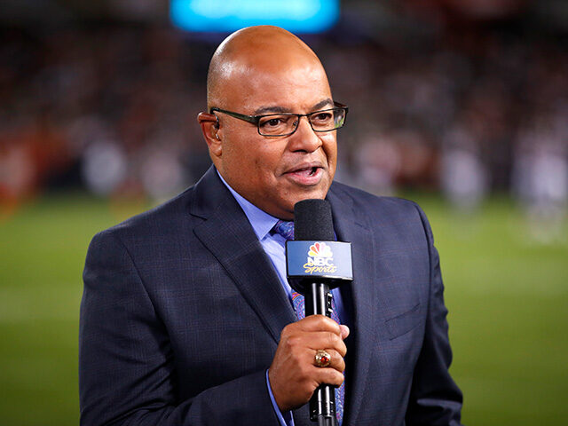 In this Sept. 5, 2019, file photo, NBC sportscaster Mike Tirico works the sidelines during