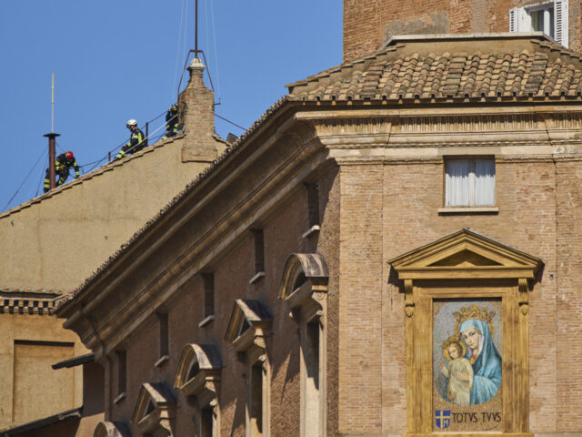 Vatican Conclave Firefighters place the chimney on the roof of the Sistine Chapel, where cardinals will gat