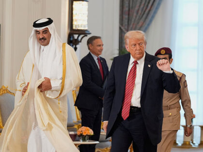 President Donald Trump gestures as he walks with Qatar's Emir Sheikh Tamim bin Hamad Al Th