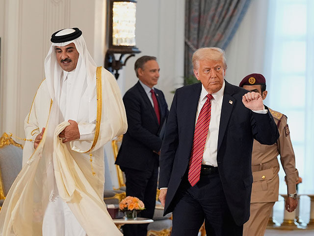 President Donald Trump gestures as he walks with Qatar's Emir Sheikh Tamim bin Hamad Al Th
