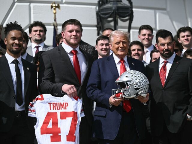 US President Donald Trump, alongside defensive end Jack Sawyer (2nd L), wide receiever Eme