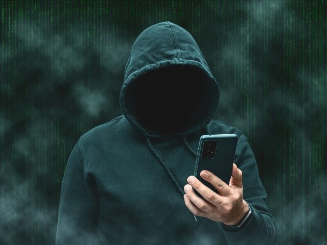 Crook using his smartphone to target victims