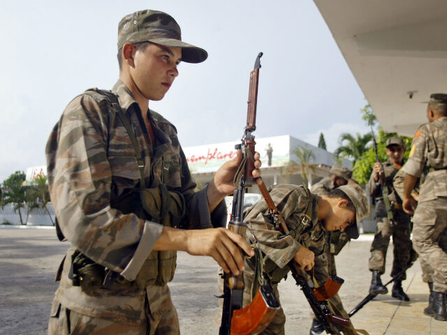 Cuban soldier Cuban soldiers hold their weapons Tuesday, Sept. 10, 2002 at Cuban Base headquarters in Gu