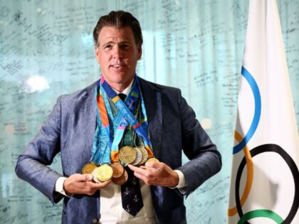 US swimmer Gary Hall Jr. (L) poses wearing the replica Olympic medals that the IOC preside