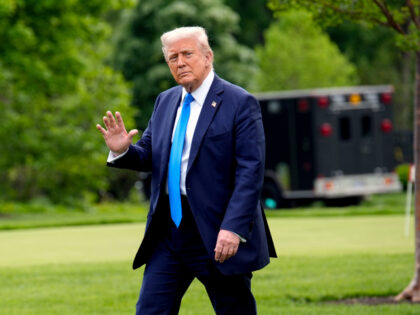 US President Donald Trump walks on the South Lawn of the White House before boarding Marin