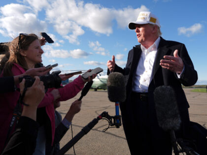 President Donald Trump speaks with reporters before boarding Air Force One at Morristown M