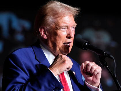 Republican presidential nominee former President Donald Trump gestures with his fists as h