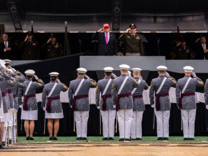 President Donald Trump salutes alongside Lieutenant General Steven W. Gilland during the U