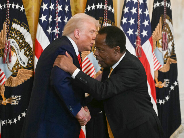 US President Donald Trump shakes hands with civil rights attorney and talk radio host Leo